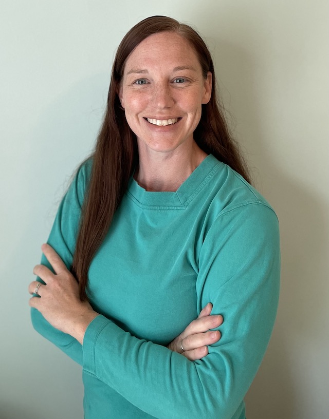 Smiling woman with teal longsleeve top