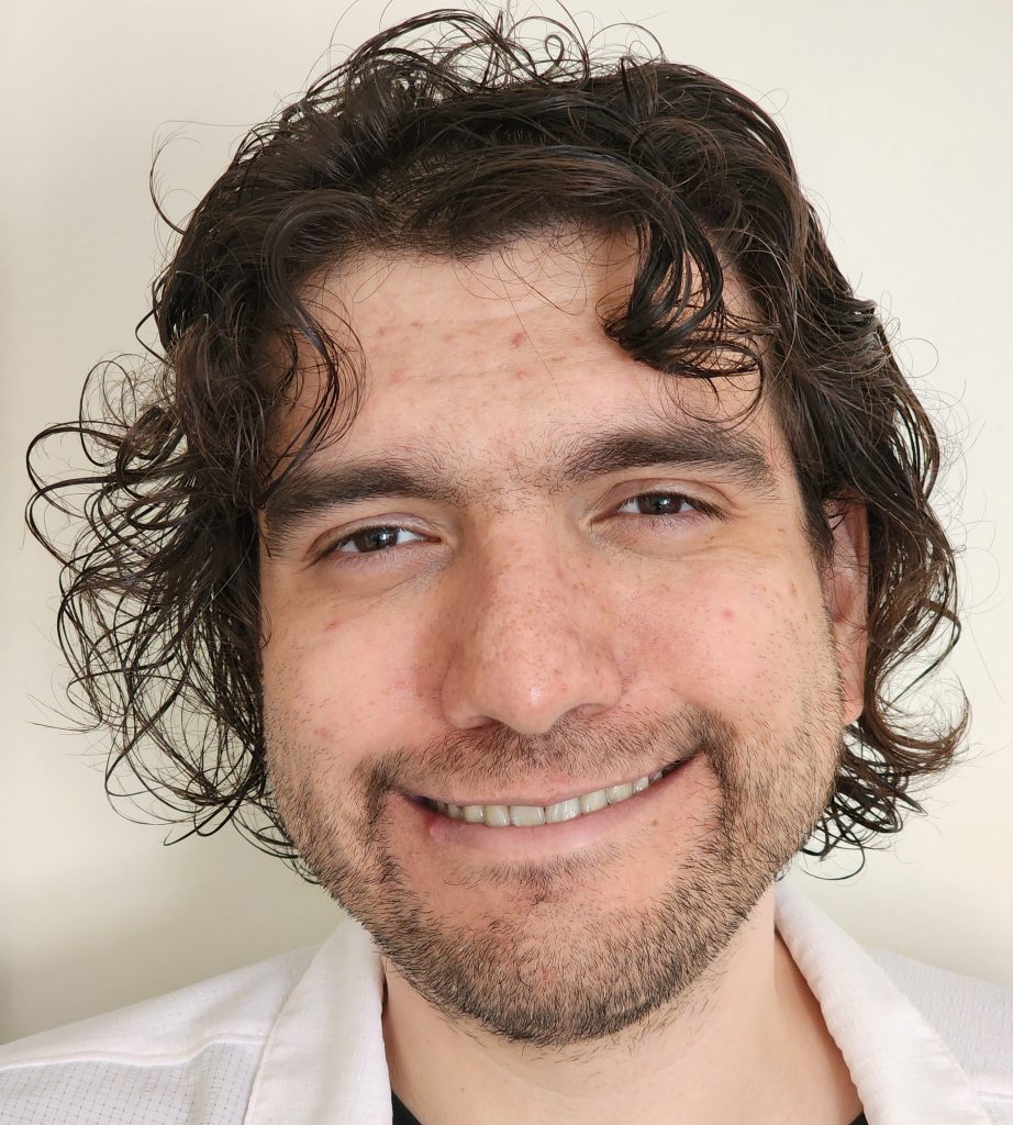 Man with a white shirt in front of a white background.