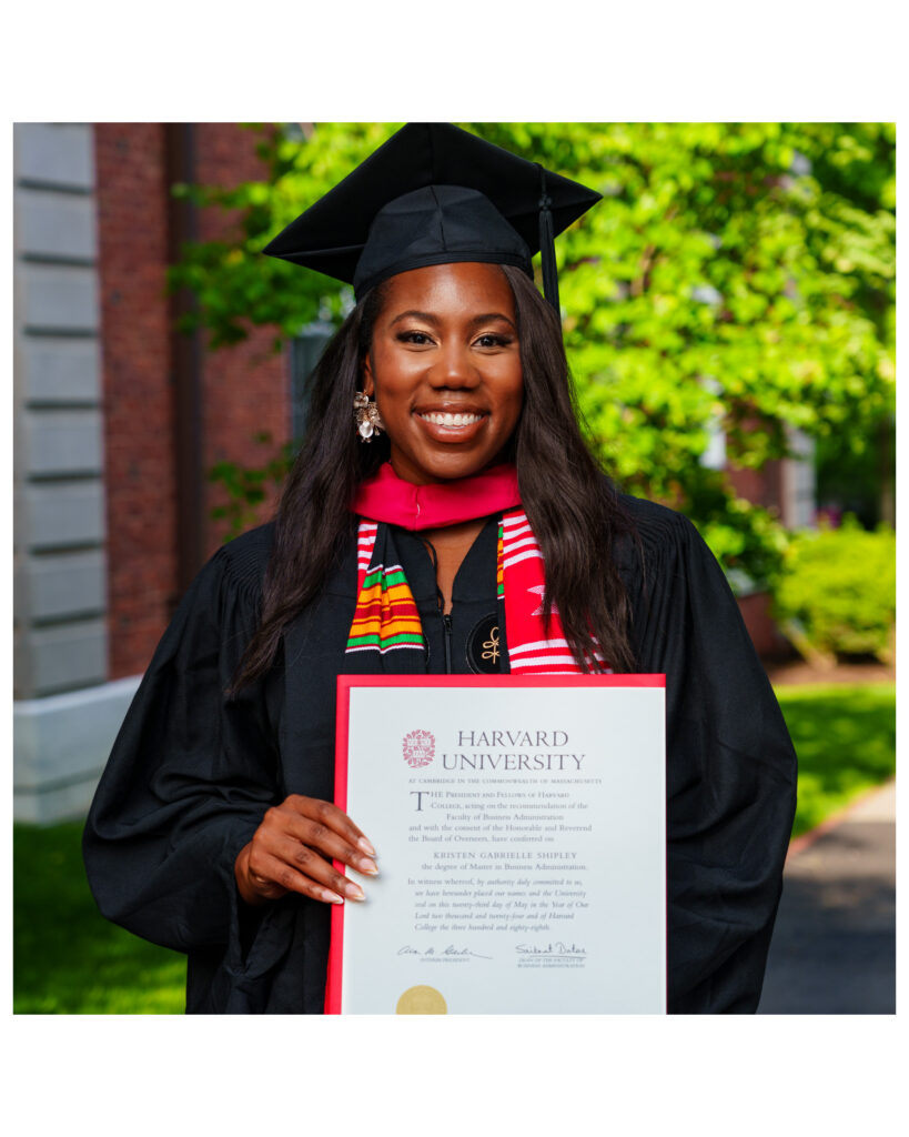 A Black woman in a black and red graduation cap and gown